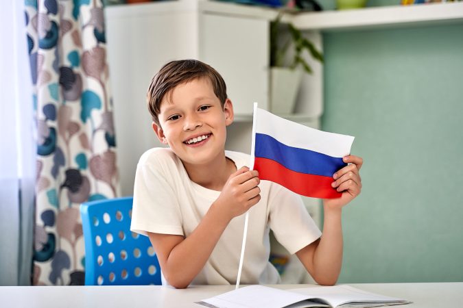 a beautiful boy with the flag of Russia. Russia Day.